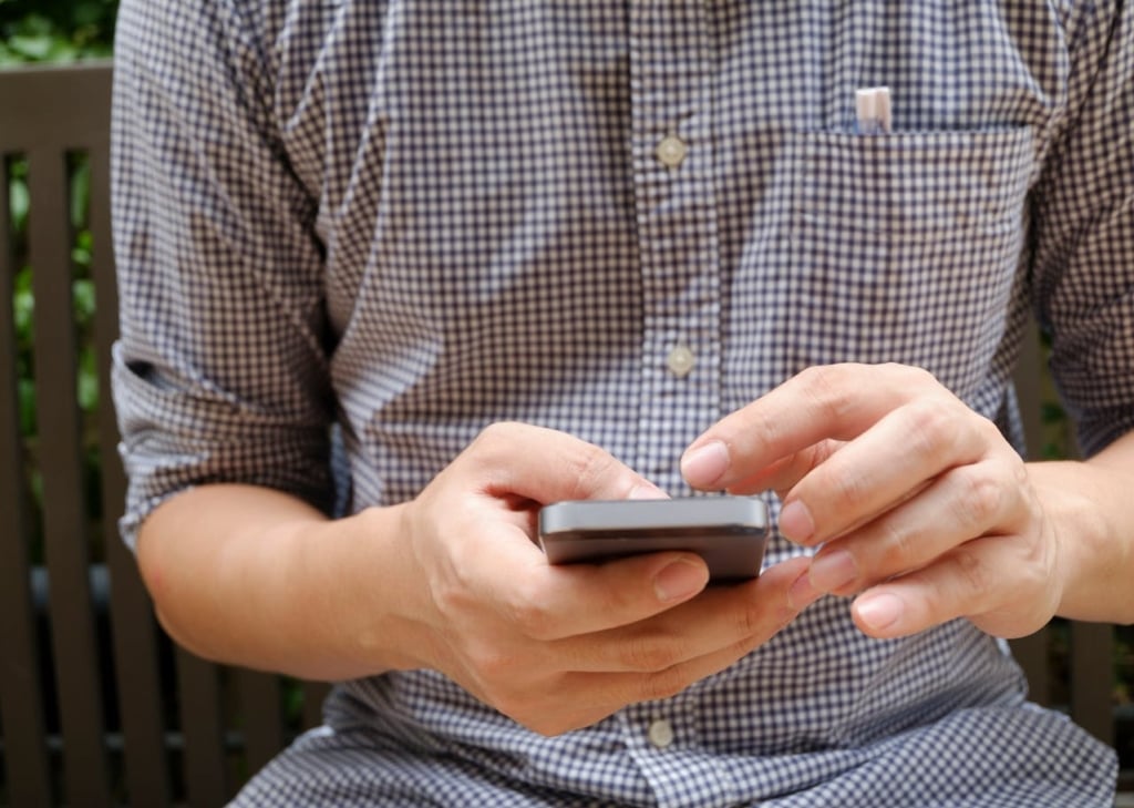 Man using a contact form on his mobile phone