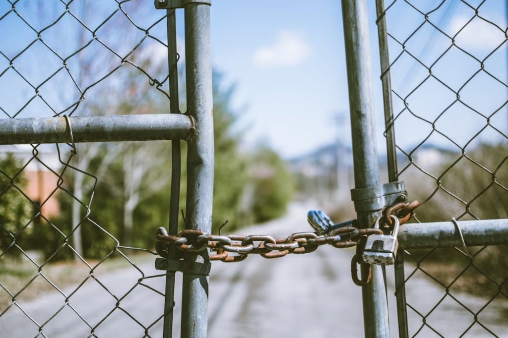 Locked gate preventing access.