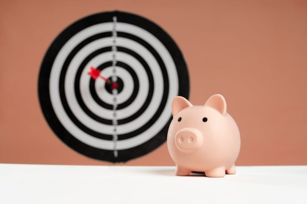 Piggy bank sitting on a table with a dart board in the background