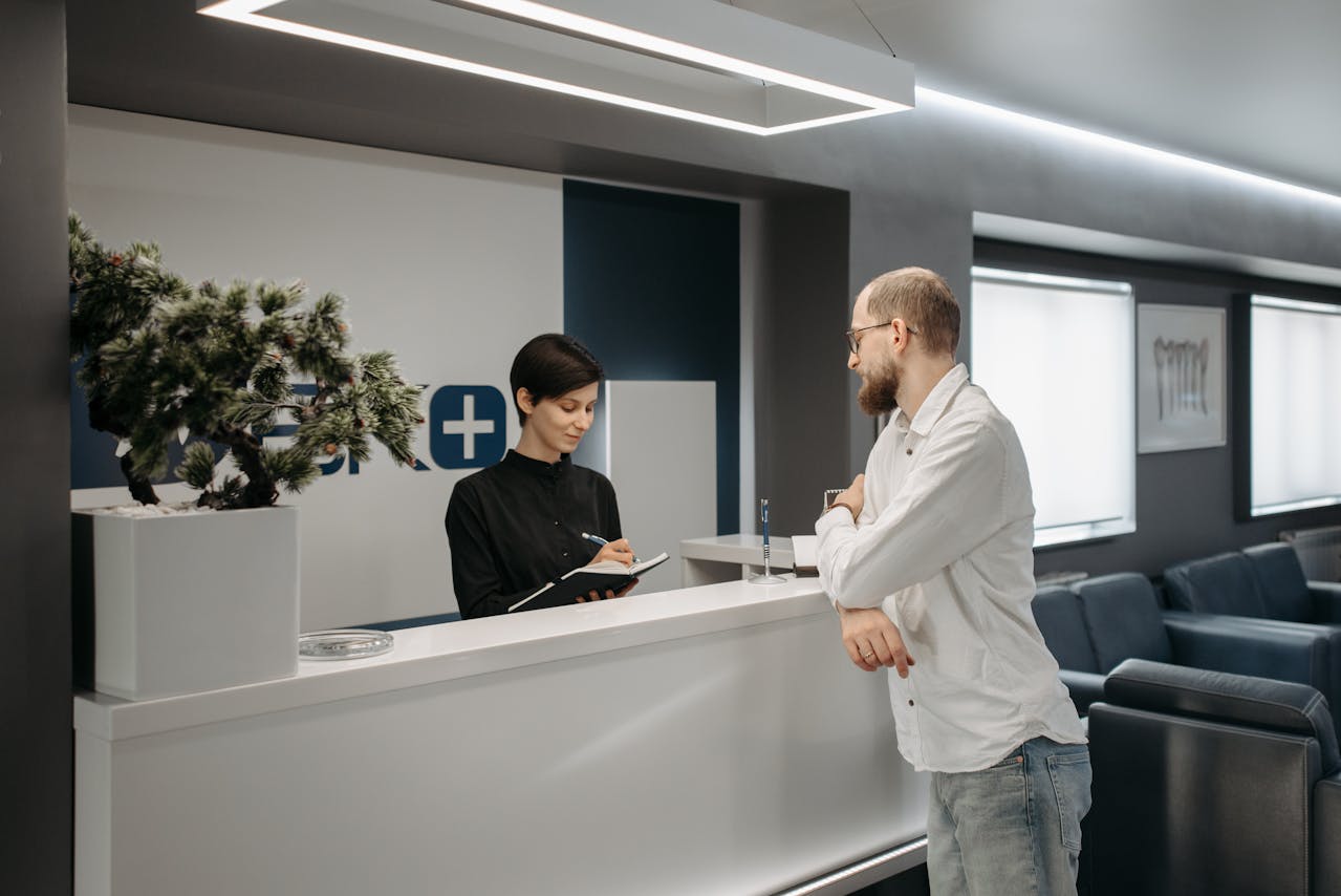Man checking in at a medical reception desk